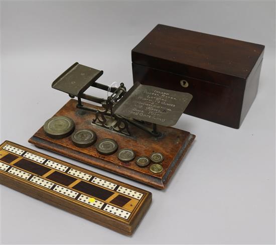 A set of Victorian postal scales and weights, a cribbage board and a tea caddy